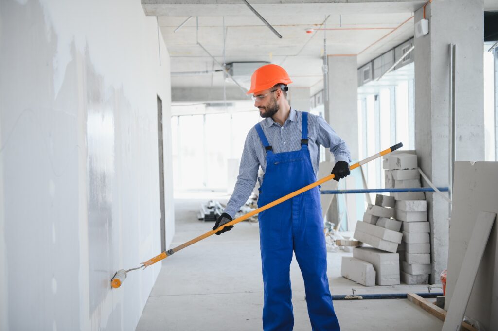 painter man painting the wall, with paint roller